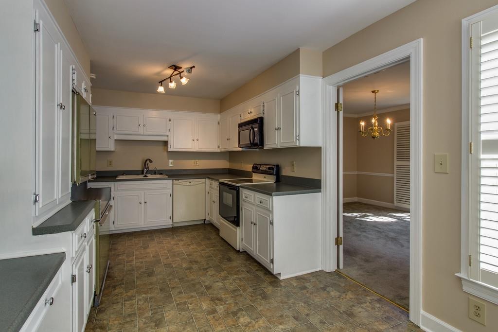 1501 Hillsboro Road Franklin, TN 37069 - Photo 10 of 24 a kitchen with granite countertop white cabinets and white appliances