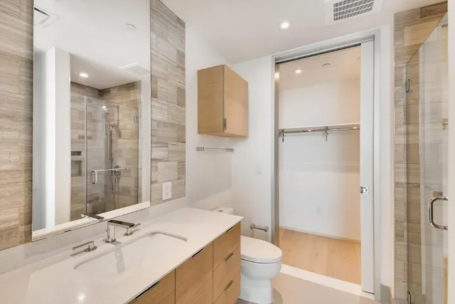 a bathroom with a sink toilet and shower