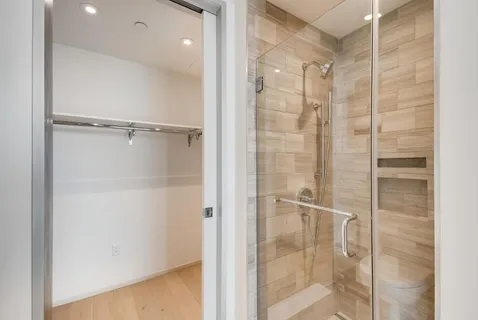 a bathroom with a glass shower door