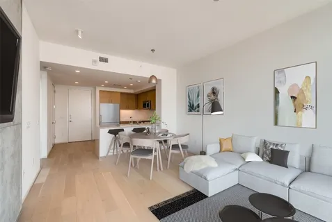 a living room with furniture and wooden floor