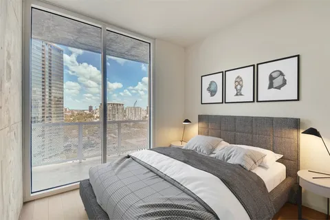 a bedroom with a large bed and a large window