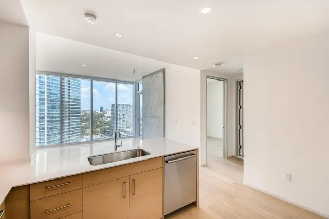 a hallway with sink and wooden floor