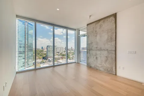 a view of a room with wooden floor and doors