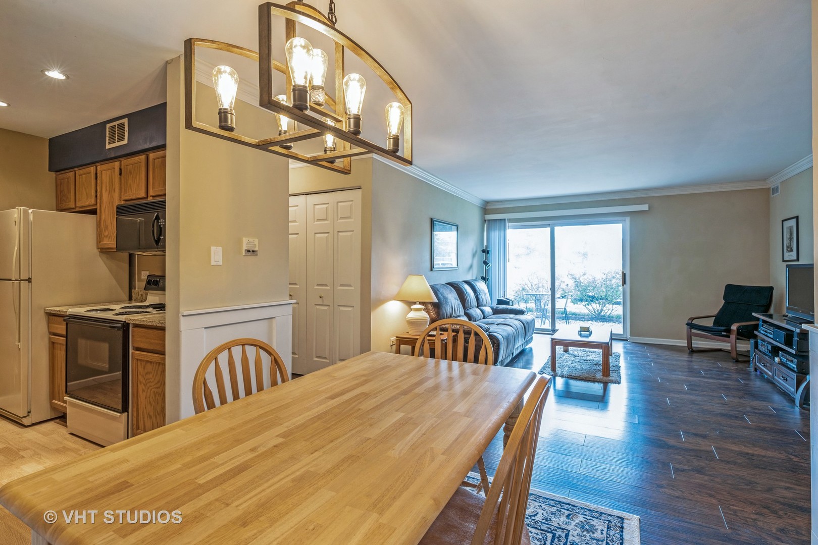 6135 Knoll Wood Road, Unit 13101 Willowbrook, IL 60527 - Photo 6 of 12 a bedroom with a bed a table and chair with wooden floor