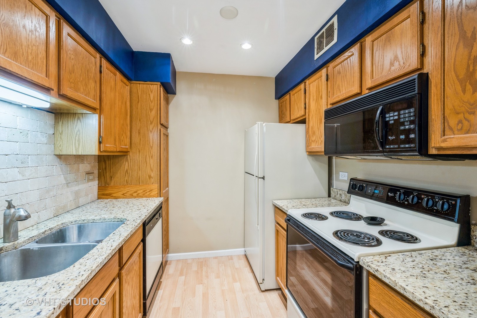 6135 Knoll Wood Road, Unit 13101 Willowbrook, IL 60527 - Photo 7 of 12 a kitchen with stainless steel appliances granite countertop a sink stove and refrigerator