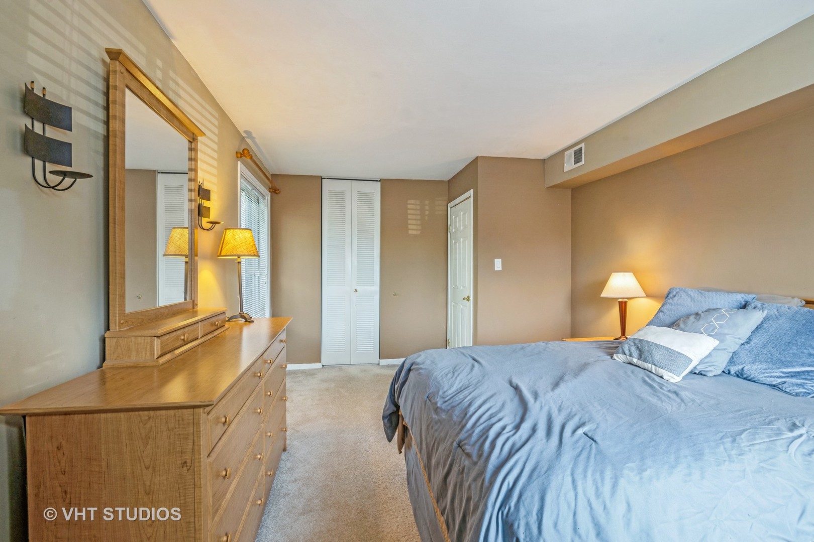 6135 Knoll Wood Road, Unit 13101 Willowbrook, IL 60527 - Photo 9 of 12 a bedroom with a bed and cabinets