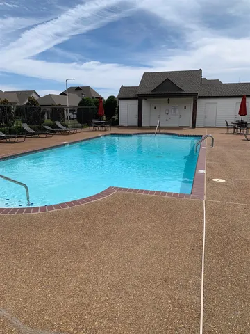 a view of a swimming pool and an outdoor space