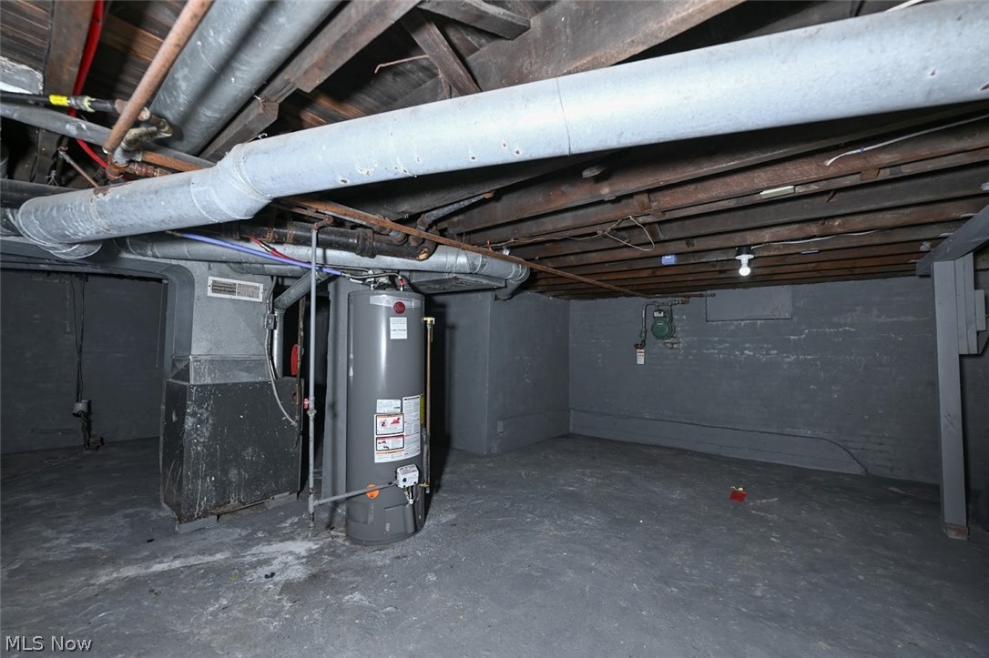 868 North Main Street Akron, OH 44310 - Photo 29 of 30 Unfinished below grade area featuring water heater and heating unit