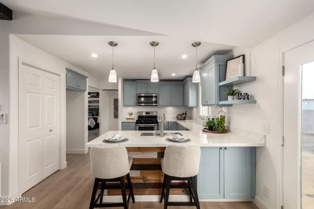 a kitchen with a sink cabinets and wooden floor