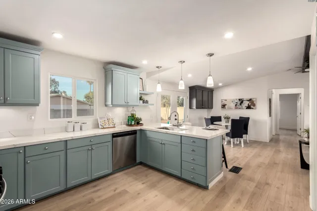 a kitchen with a sink a stove and cabinets