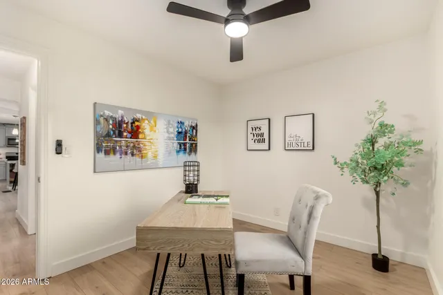 a bathroom with a granite countertop sink a mirror and shower