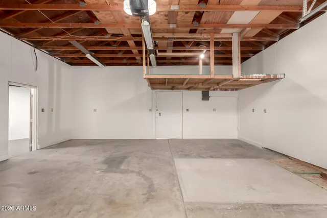a view of a dry yard with wooden fence