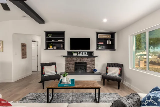 a living room with fireplace furniture and a flat screen tv