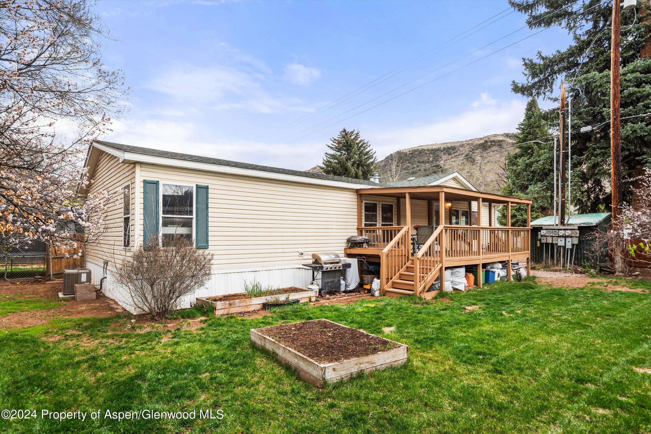 a view of a house with a yard patio and a fire pit