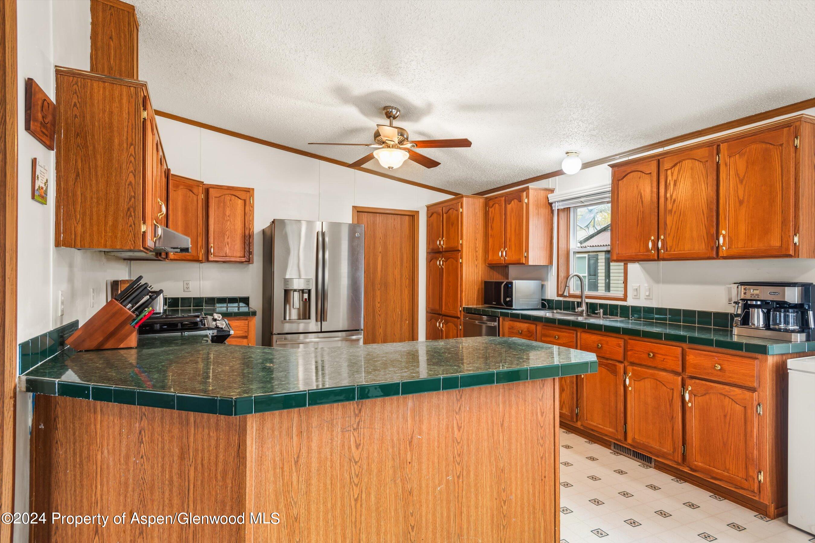 71 Nathan El Jebel, CO 81623 - Photo 6 of 29 a kitchen with stainless steel appliances granite countertop a sink a stove counter space and cabinets