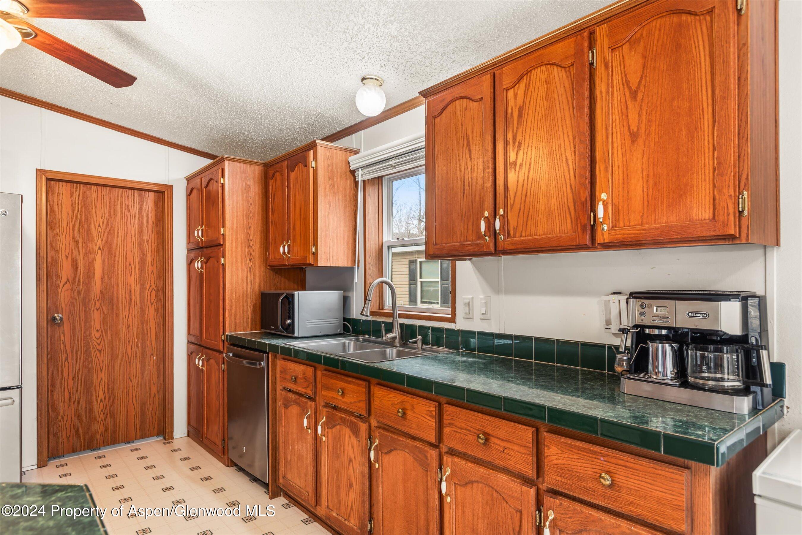 71 Nathan El Jebel, CO 81623 - Photo 7 of 29 a kitchen with stainless steel appliances granite countertop wooden cabinets a sink and a counter space