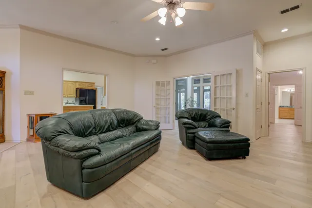 a living room with furniture and a chandelier