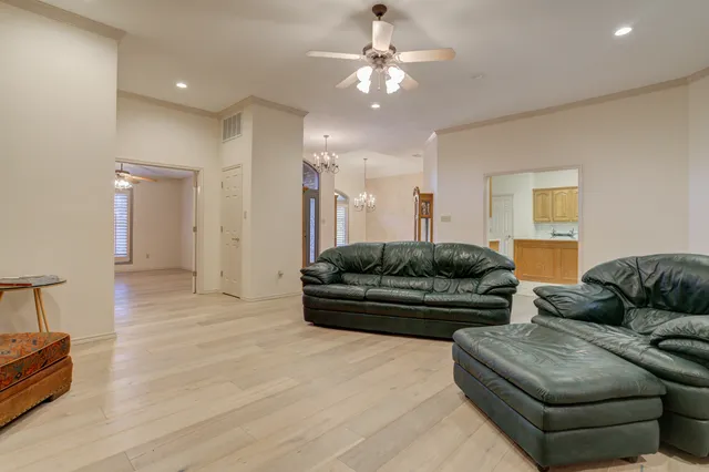 a large kitchen with stainless steel appliances wooden cabinets and a counter top space