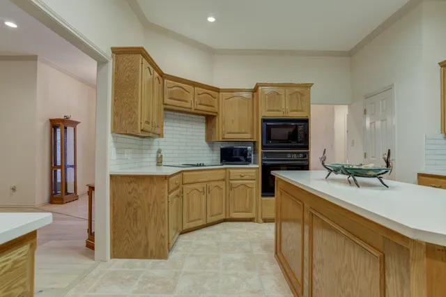 a kitchen with cabinets appliances and a wooden floor