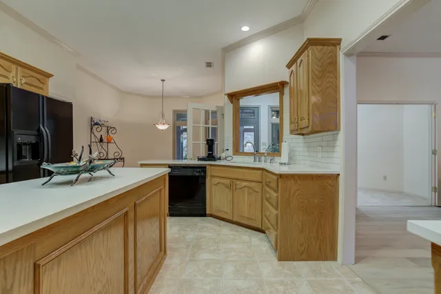 a kitchen with stainless steel appliances granite countertop a refrigerator a sink and a stove