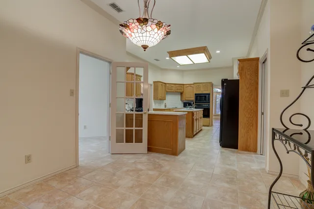 a bathroom with a granite countertop double vanity sink and a mirror