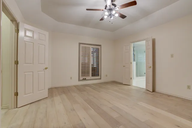 a white bath tub sitting in a bathroom next to a window