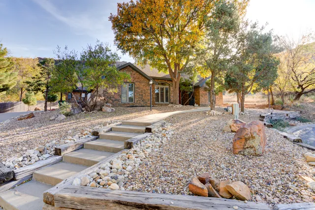 a backyard of a house with table and chairs