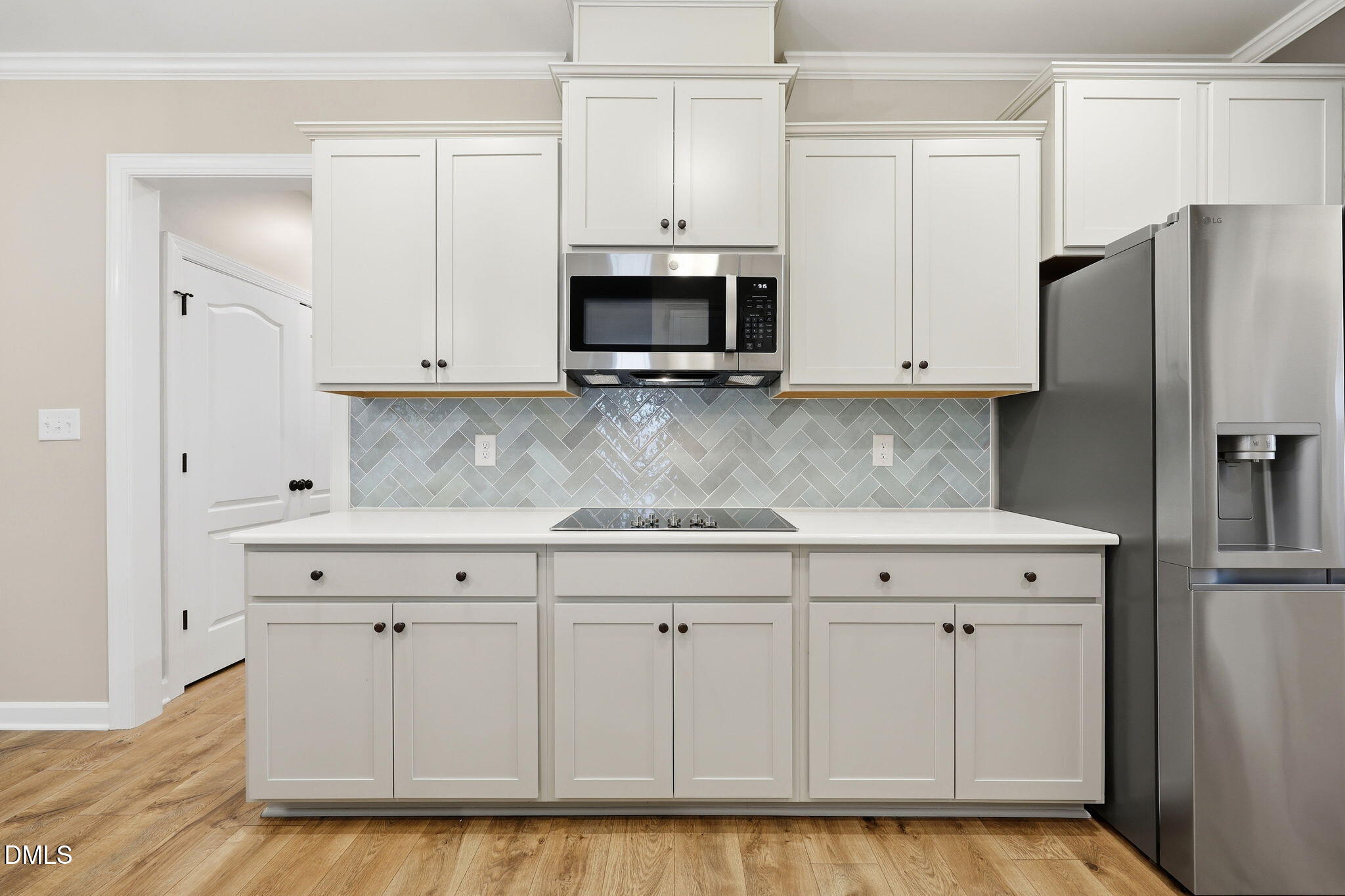 146 Seahawk Way Zebulon, NC 27597 - Photo 18 of 51 a kitchen with stainless steel appliances white cabinets and a refrigerator