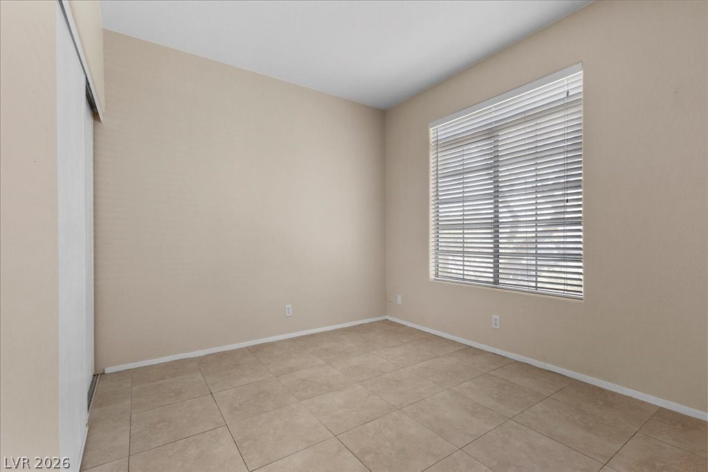 2201 Ramsgate Drive, Unit 818 Henderson, NV 89074 - Photo 16 of 32 Empty room with light tile patterned floors and baseboards