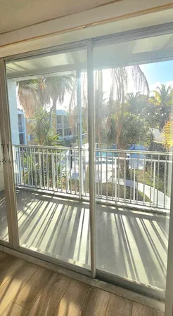 a view of a room with wooden floor and windows