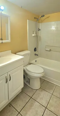 a bathroom with a toilet sink vanity and shower