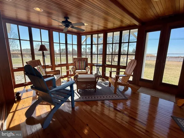 a view of a room with wooden floor and a window