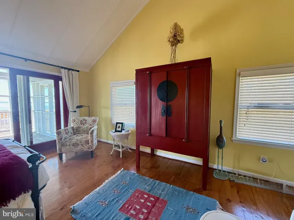 a living room with furniture a window and a wooden floor