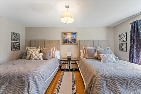 a bedroom with double bed and a chandelier