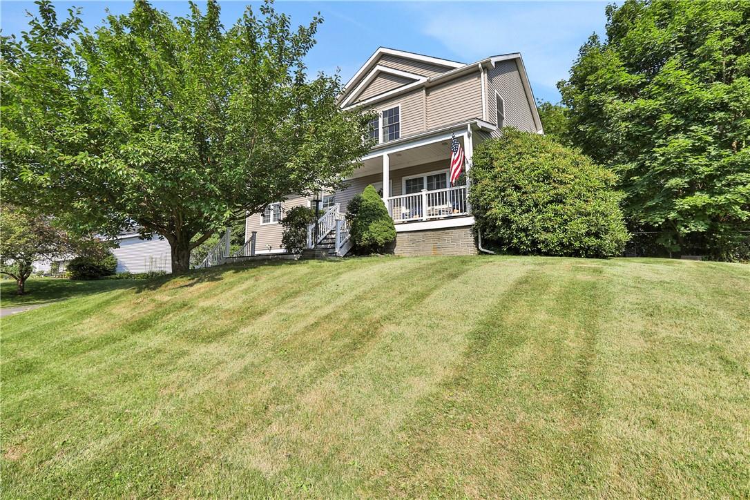 a view of a house with backyard and trees