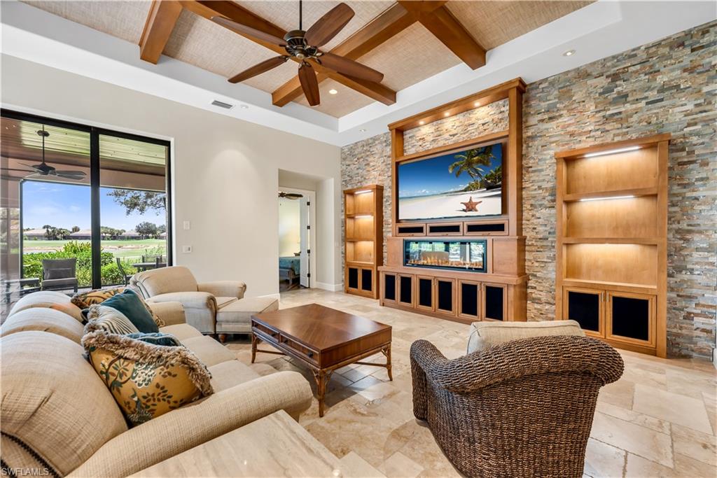 11875 Hedgestone Court Naples, FL 34120 - Photo 11 of 29 Tray ceiling with wood beam accents and a ceiling fan