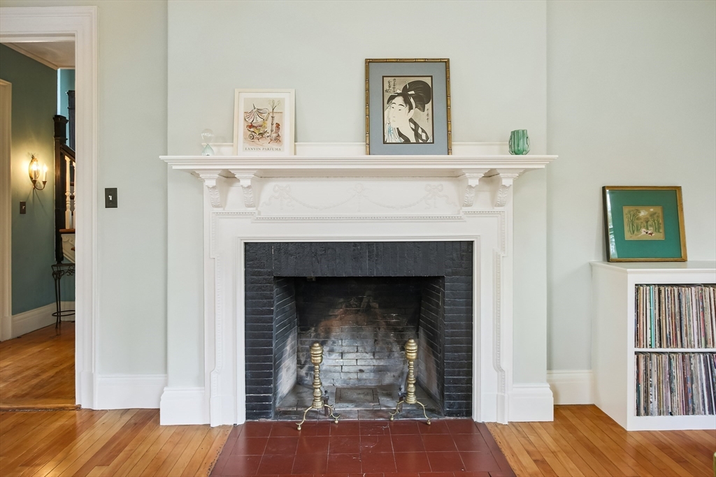 61 William Street Worcester, MA 01609 - Photo 13 of 42 a living room with a fireplace and a wooden floor
