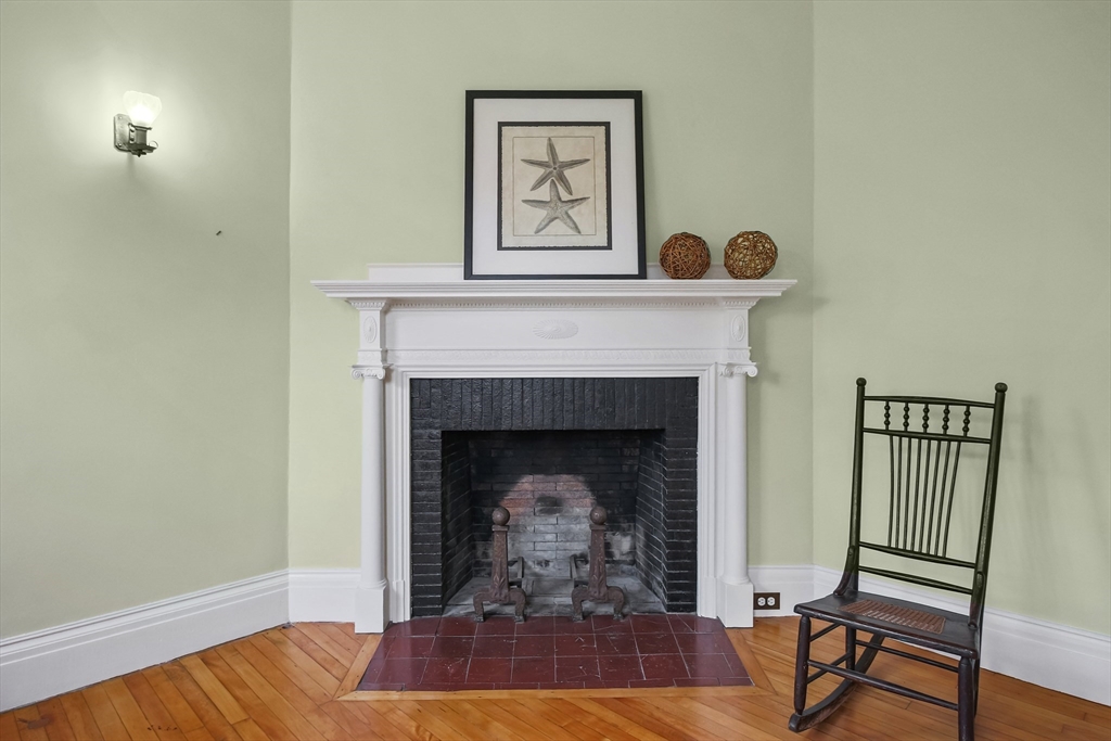61 William Street Worcester, MA 01609 - Photo 15 of 42 a living room with a fireplace and a table