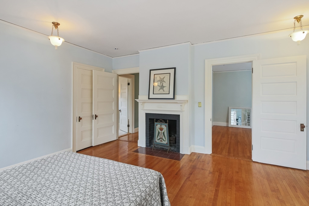 61 William Street Worcester, MA 01609 - Photo 24 of 42 a bedroom with a bed and a fireplace