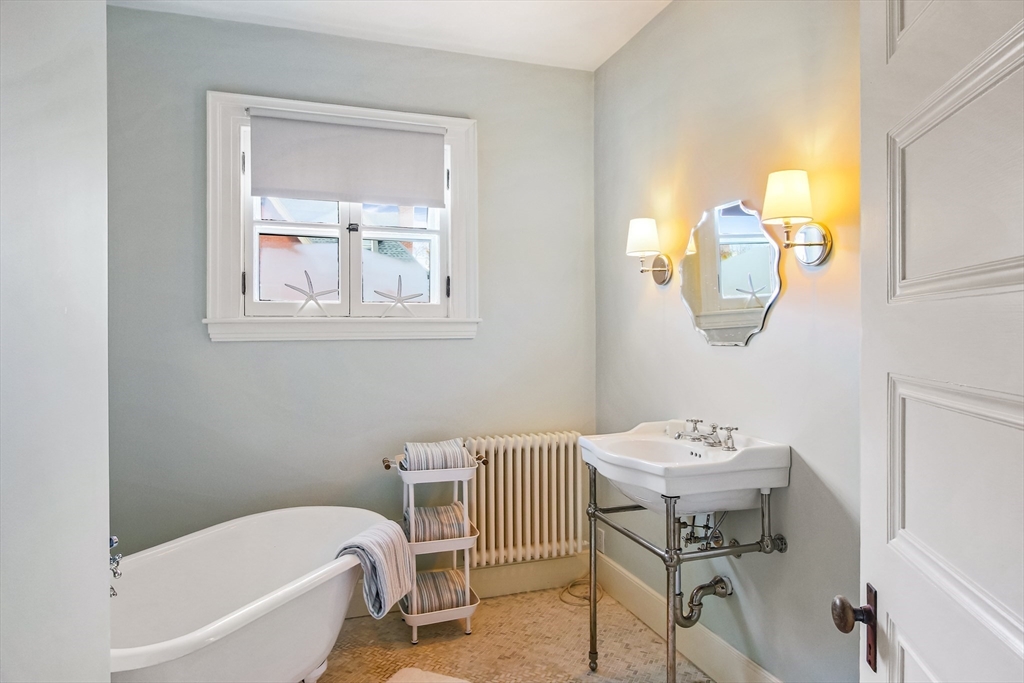 61 William Street Worcester, MA 01609 - Photo 25 of 42 a bathroom with a sink a bathtub and a window