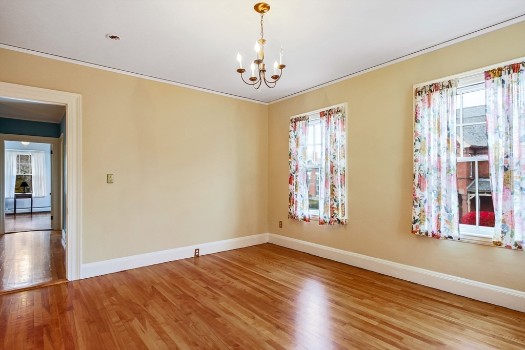 61 William Street Worcester, MA 01609 - Photo 27 of 42 a view of an empty room with window and wooden floor