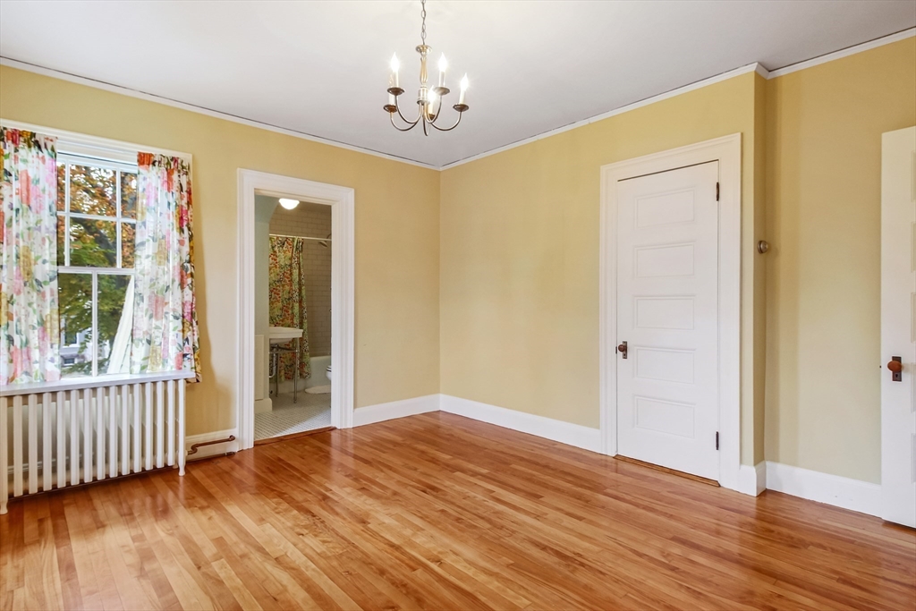 61 William Street Worcester, MA 01609 - Photo 28 of 42 an empty room with wooden floor and windows