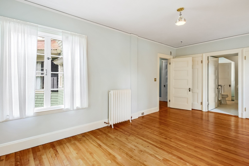 61 William Street Worcester, MA 01609 - Photo 31 of 42 a view of an empty room with wooden floor and a window