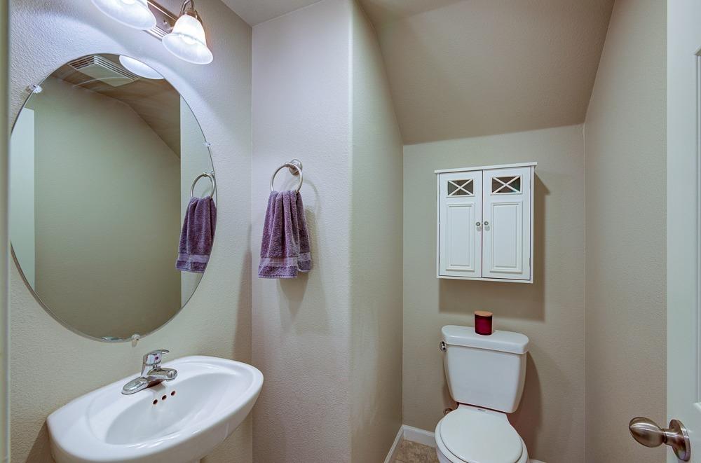 3518 Significant Way Clovis, CA 93619 - Photo 12 of 34 a bathroom with a toilet sink and mirror