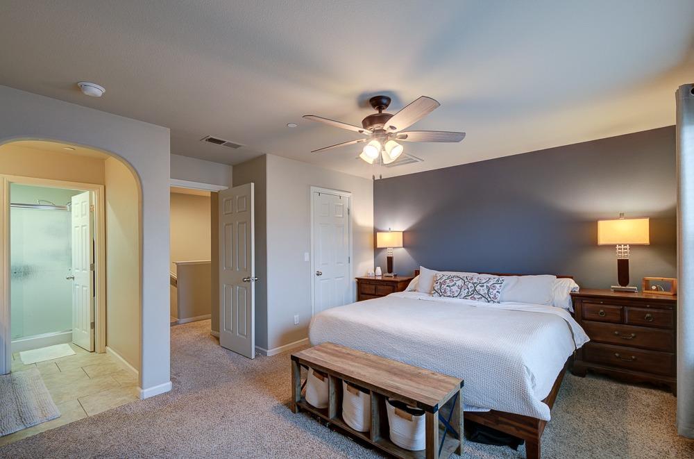 3518 Significant Way Clovis, CA 93619 - Photo 17 of 34 a bedroom with a bed and a chandelier