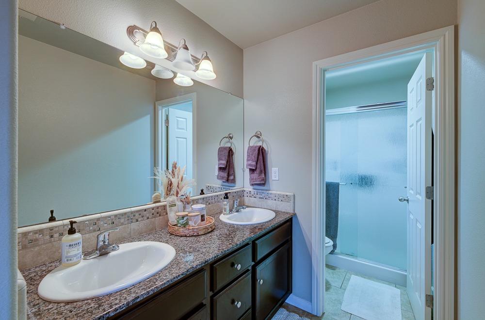 3518 Significant Way Clovis, CA 93619 - Photo 18 of 34 a bathroom with a sink double vanity granite and a mirror