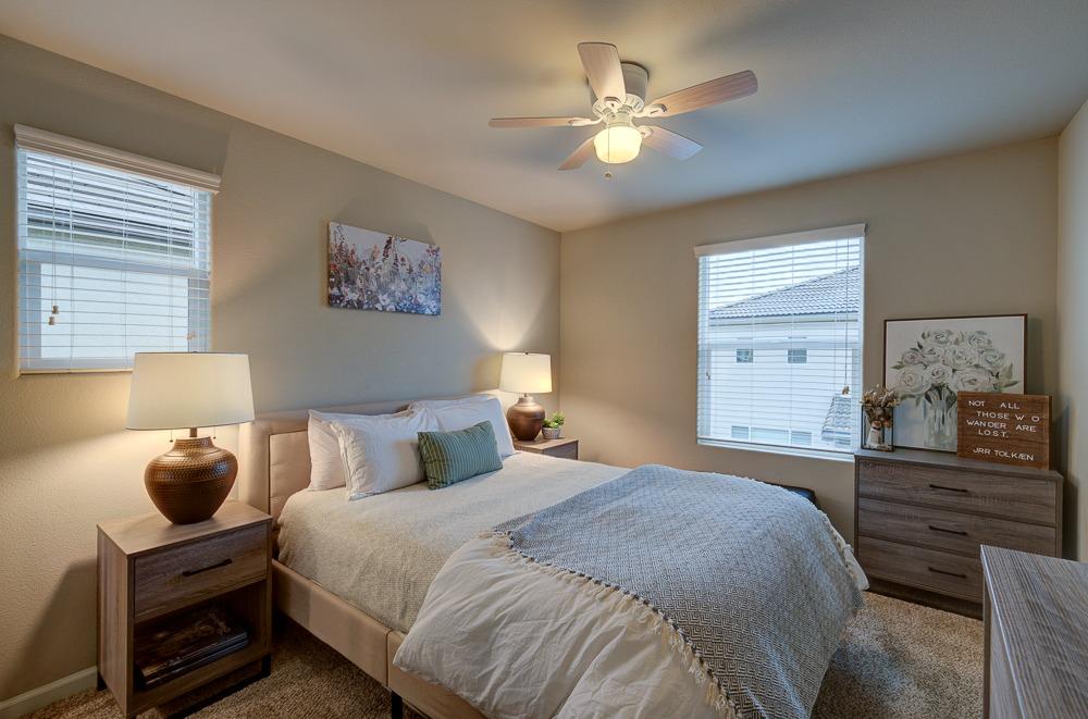 3518 Significant Way Clovis, CA 93619 - Photo 23 of 34 a bedroom with a bed and a chandelier