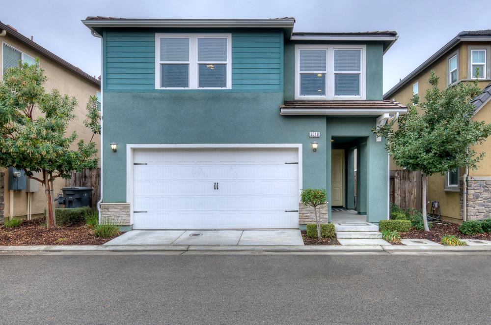 3518 Significant Way Clovis, CA 93619 - Photo 29 of 34 a front view of a house with a yard and garage