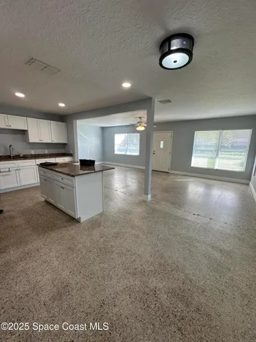 a view of a kitchen with a sink and cabinets