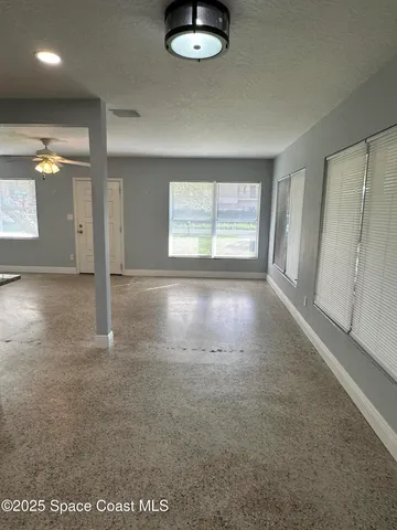 an empty room with windows and entrance